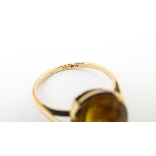 647 - A 9ct gold ring set with oval citrine. Ring size approx. P