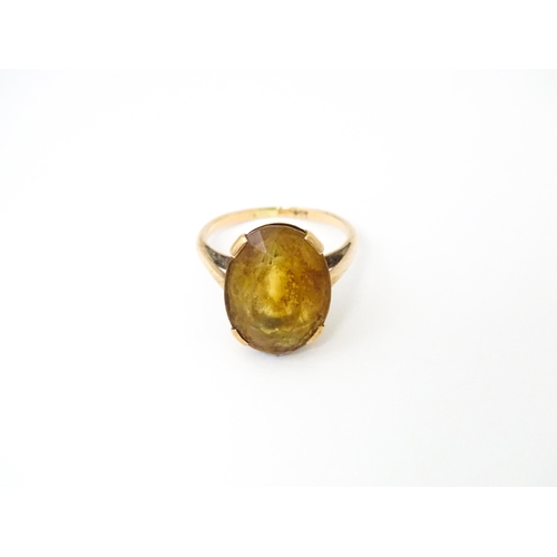 647 - A 9ct gold ring set with oval citrine. Ring size approx. P