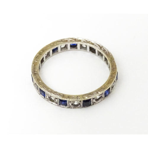 648 - A 9ct gold eternity ring set with sapphires and white stones. Ring size approx. M 1/2