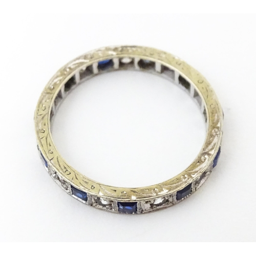 648 - A 9ct gold eternity ring set with sapphires and white stones. Ring size approx. M 1/2