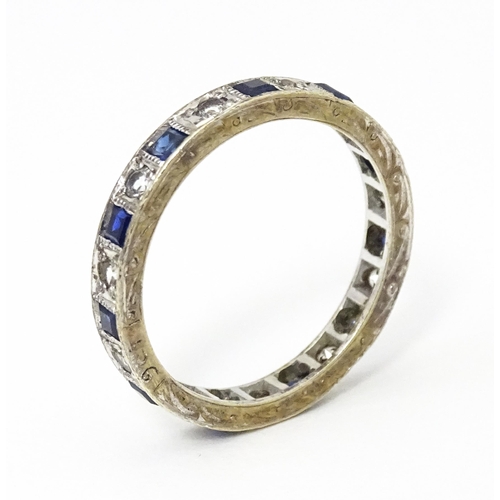 648 - A 9ct gold eternity ring set with sapphires and white stones. Ring size approx. M 1/2