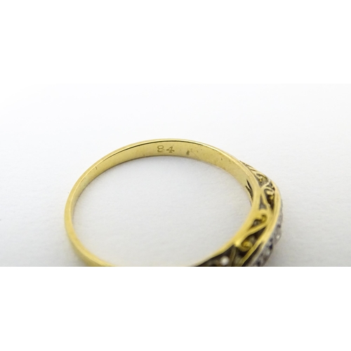 650 - An 18ct gold ring set with 5 graduated diamonds. Ring size approx. M