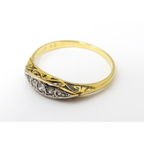 650 - An 18ct gold ring set with 5 graduated diamonds. Ring size approx. M