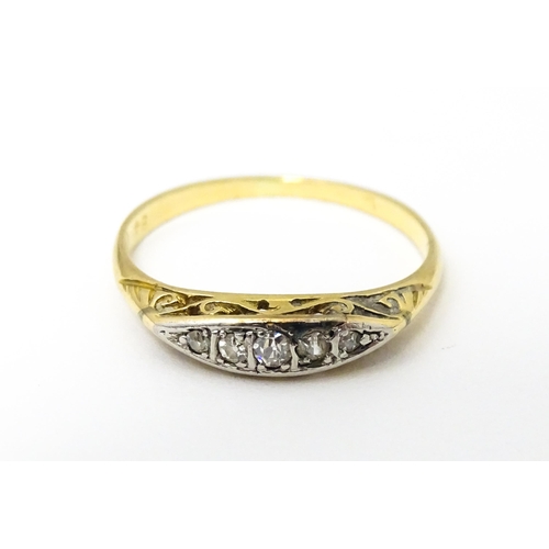 650 - An 18ct gold ring set with 5 graduated diamonds. Ring size approx. M