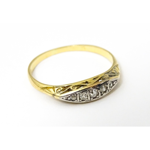 650 - An 18ct gold ring set with 5 graduated diamonds. Ring size approx. M