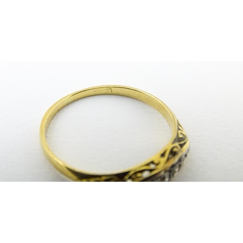 650 - An 18ct gold ring set with 5 graduated diamonds. Ring size approx. M