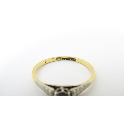 652 - An 18ct gold ring with platinum set diamond. Ring size approx. M