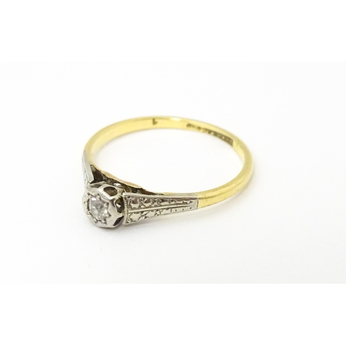 652 - An 18ct gold ring with platinum set diamond. Ring size approx. M