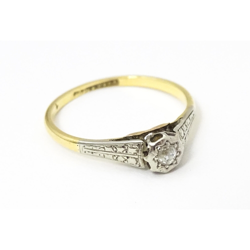 652 - An 18ct gold ring with platinum set diamond. Ring size approx. M