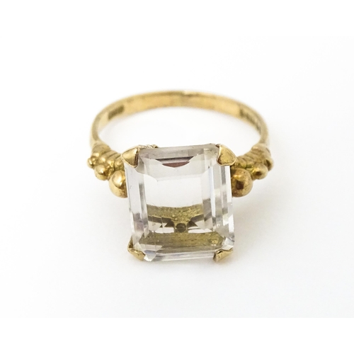 654 - A 9ct gold ring set white stone. Hallmarked London 1965 maker AJLd. Ring size approx. M.