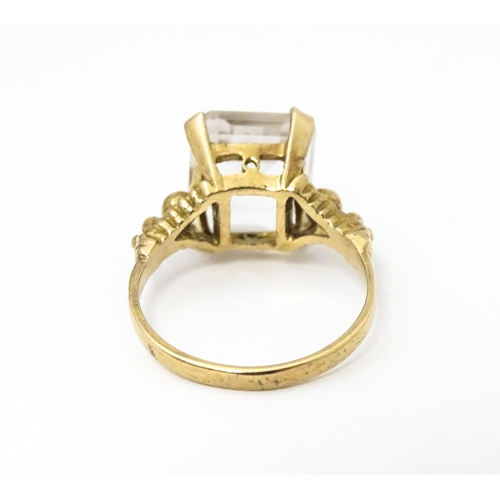 654 - A 9ct gold ring set white stone. Hallmarked London 1965 maker AJLd. Ring size approx. M.