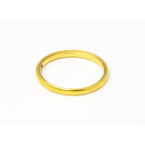 655 - A 22ct gold ring, retailed by Bravingtons. Ring size approx. N