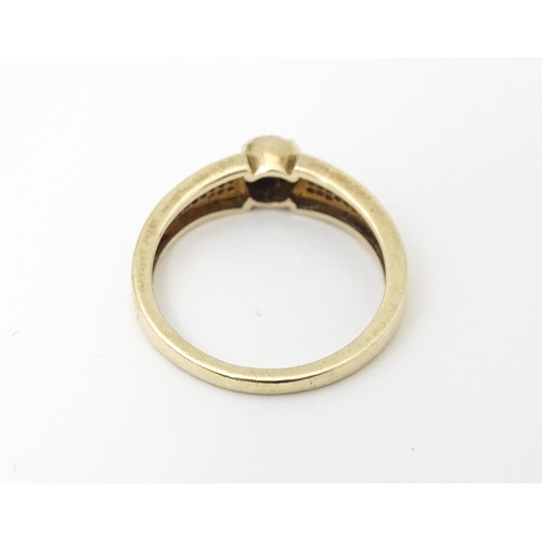 657 - A 9ct gold ring set with diamonds. Ring size approx. M 1/2