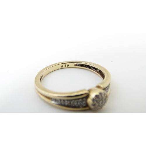 657 - A 9ct gold ring set with diamonds. Ring size approx. M 1/2