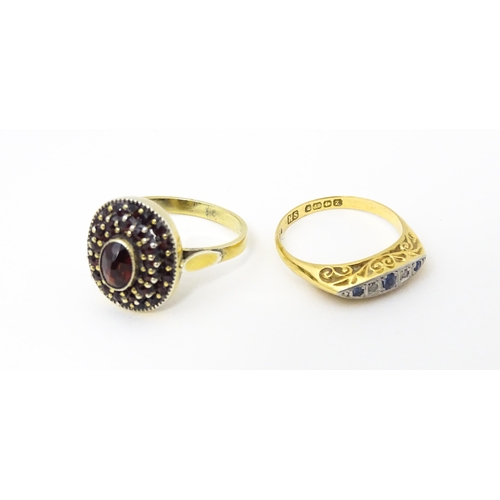 662 - An 18ct gold ring set with diamonds and sapphires together with a Continental silver gilt ring set w... 