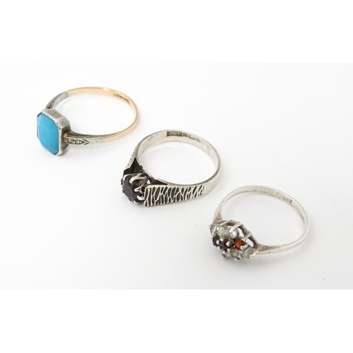 672 - Three various rings to include a silver ring set with garnets, hallmarked Birmingham 1979, together ... 