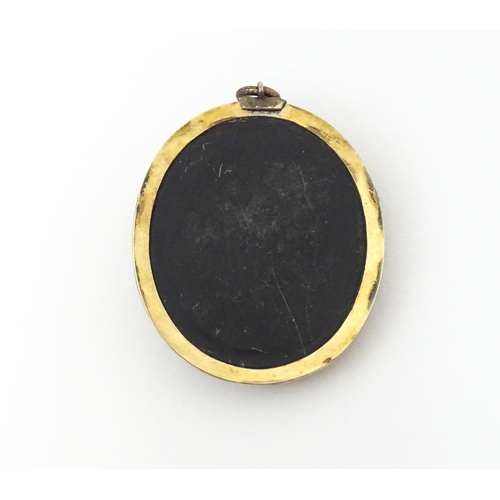 674 - A Victorian black lava cameo pendant in yellow metal mount. Approx 1 1/42 long