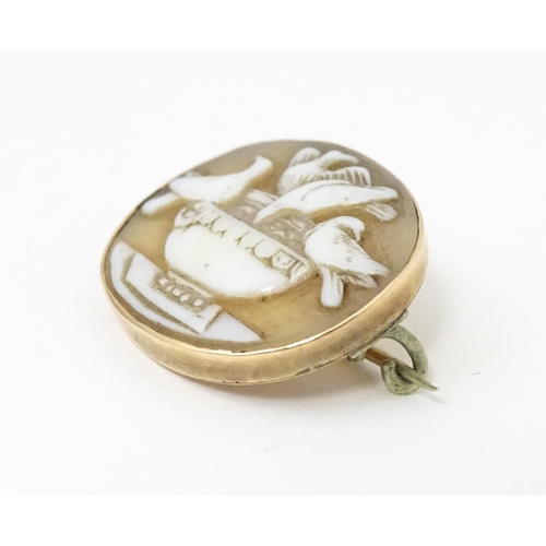 678 - A Victorian cameo brooch with bird decoration, within a yellow metal mount. 1