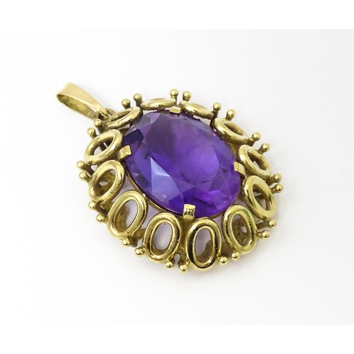 680 - A 9ct gold pendant set with central amethyst. Approx 1 1/2