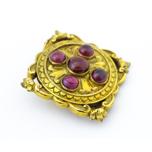 682 - A Victorian yellow metal brooch set with five garnet cabochon , approx 1 3/4