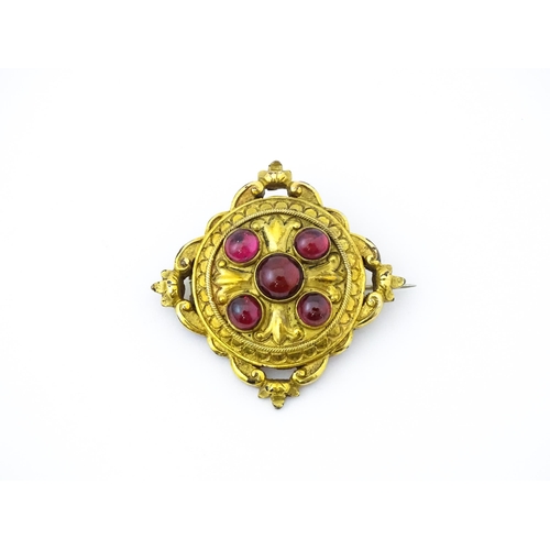 682 - A Victorian yellow metal brooch set with five garnet cabochon , approx 1 3/4