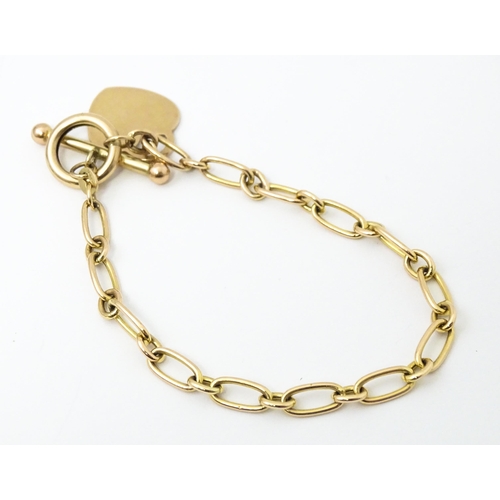 683 - A 9ct gold and yellow metal bracelet.