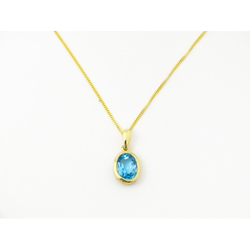 684 - A 9ct gold pendant set with topaz on an 18