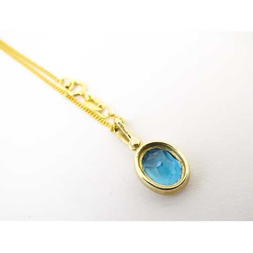 684 - A 9ct gold pendant set with topaz on an 18