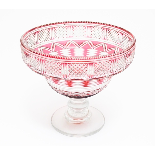 259 - A 19thC cut glass /  crystal pedestal bowl with cranberry flash detail. Approx 9 1/2