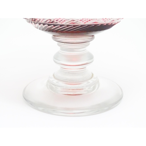 259 - A 19thC cut glass /  crystal pedestal bowl with cranberry flash detail. Approx 9 1/2