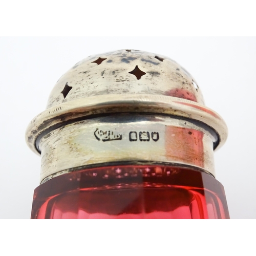 282 - A cranberry glass sugar shaker with a silver lid hallmarked London 1906. Together with a cranberry g... 