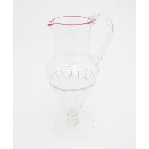 286 - Salviati & Co. Glassware: A Venetian glass jug of pedestal form with pink detail to rim. Bears label... 