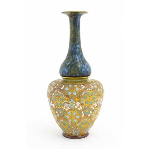 103 - A Doulton Lambeth ovoid vase with mottled blue glaze to neck and lace work floral detail to body. Im... 