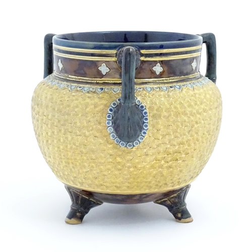 104 - A Royal Doulton stoneware gilt circle tyg of cauldron form with three mottled blue handles, banded d... 