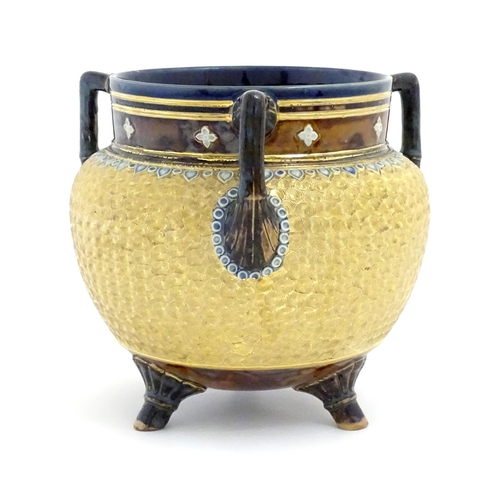 104 - A Royal Doulton stoneware gilt circle tyg of cauldron form with three mottled blue handles, banded d... 