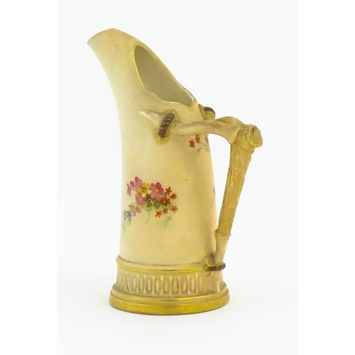 114 - A Royal Worcester blush ivory jug, the body decorated with floral sprays, the handle modelled as an ... 