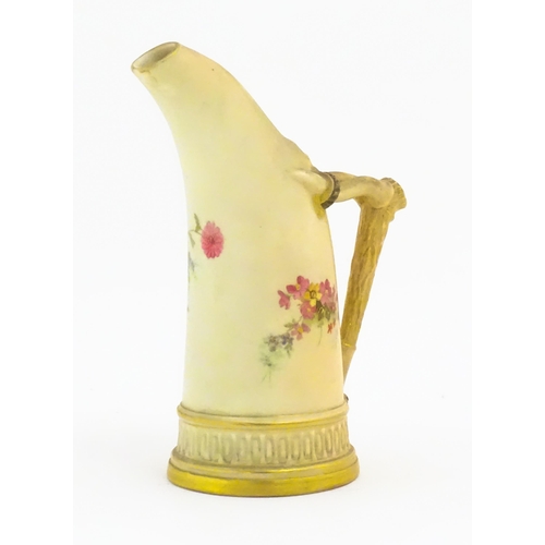 114 - A Royal Worcester blush ivory jug, the body decorated with floral sprays, the handle modelled as an ... 