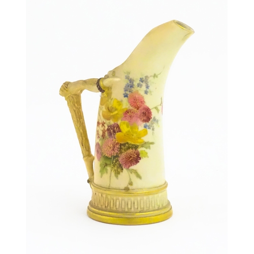 114 - A Royal Worcester blush ivory jug, the body decorated with floral sprays, the handle modelled as an ... 