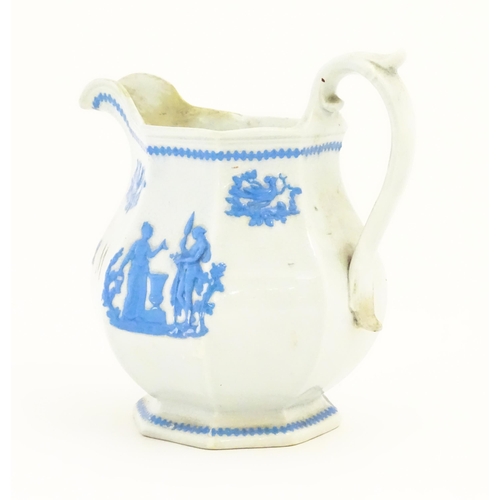 115 - A Victorian marriage jug, the cream ground decorated in blue relief depicting figures, Classical urn... 