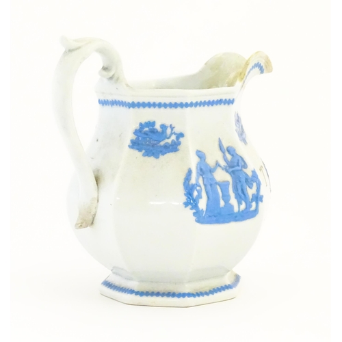 115 - A Victorian marriage jug, the cream ground decorated in blue relief depicting figures, Classical urn... 