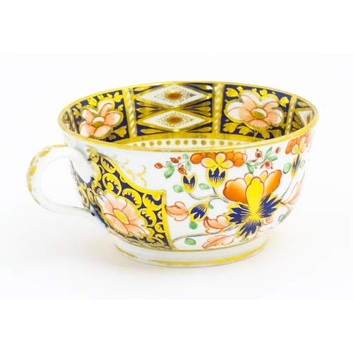 118 - A Derby porcelain tea cup and saucer decorated in the Imari pattern. Marked under. Saucer approx. Cu... 