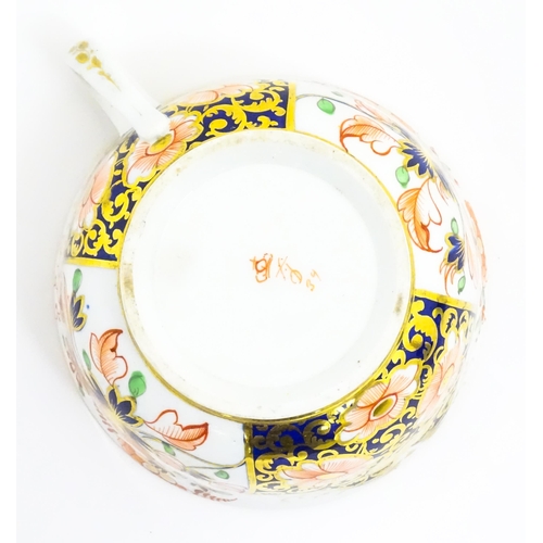 118 - A Derby porcelain tea cup and saucer decorated in the Imari pattern. Marked under. Saucer approx. Cu... 