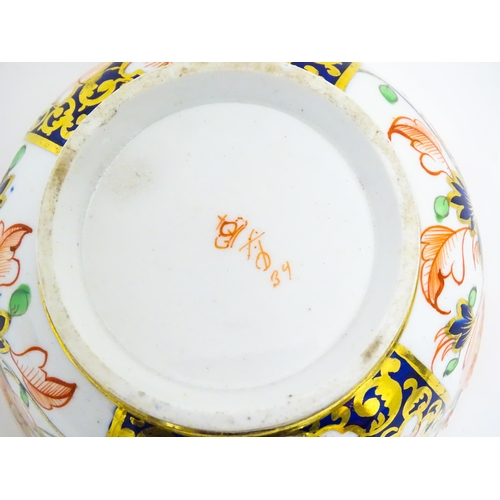 118 - A Derby porcelain tea cup and saucer decorated in the Imari pattern. Marked under. Saucer approx. Cu... 