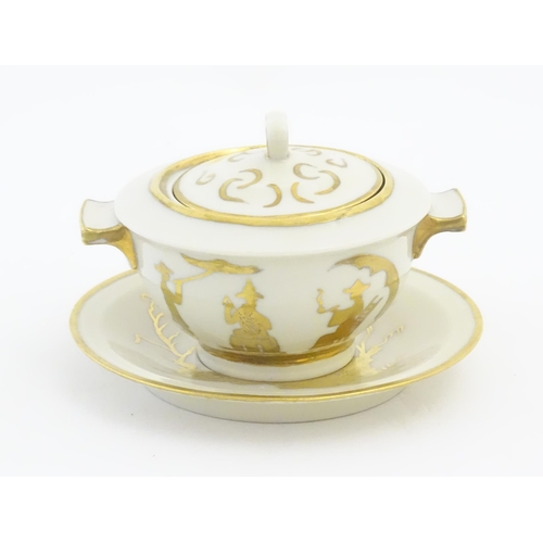 125A - A French Theo Haviland consomme pot with saucer, decorated with gilt chinoiserie detail. Marked unde... 