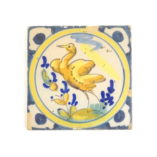 130 - A Continental Delft style tile depicting a bird within a roundel, with shaped detail to corners. App... 