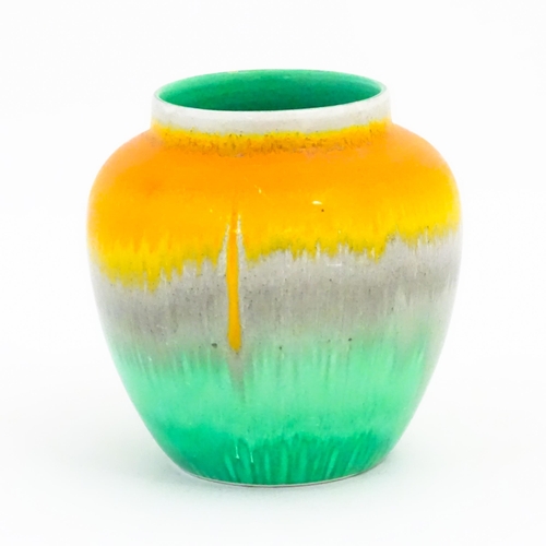 132 - A Shelley Art Deco vase / jar with a drip glaze in orange, grey and green. Marked under. Approx. 4 1... 