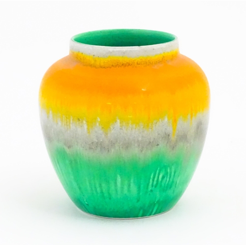 132 - A Shelley Art Deco vase / jar with a drip glaze in orange, grey and green. Marked under. Approx. 4 1... 