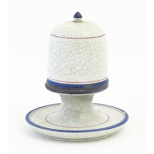 133 - A ceramic table top vesta / match keep of pedestal form with cover with a crackle glaze and banded d... 