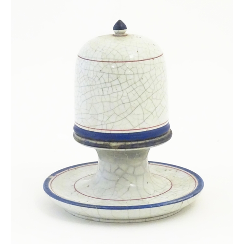 133 - A ceramic table top vesta / match keep of pedestal form with cover with a crackle glaze and banded d... 