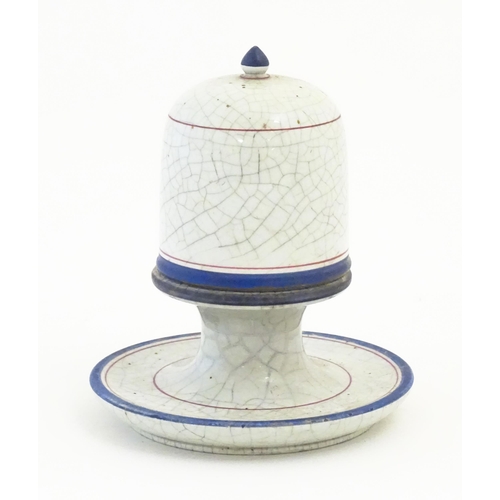 133 - A ceramic table top vesta / match keep of pedestal form with cover with a crackle glaze and banded d... 